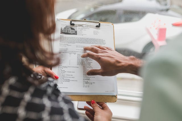 A couple reviewing a warranty from a refinishing company
