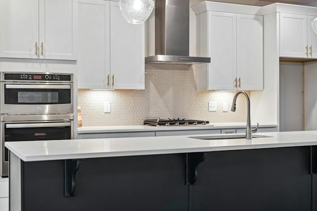 An elegantly designed kitchen showcasing essential appliances such as a sink, stove, and refrigerator